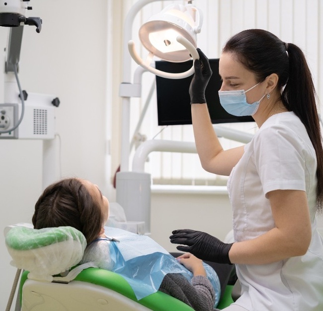 aucasian woman dentist doctor in office with dental equipment microscope