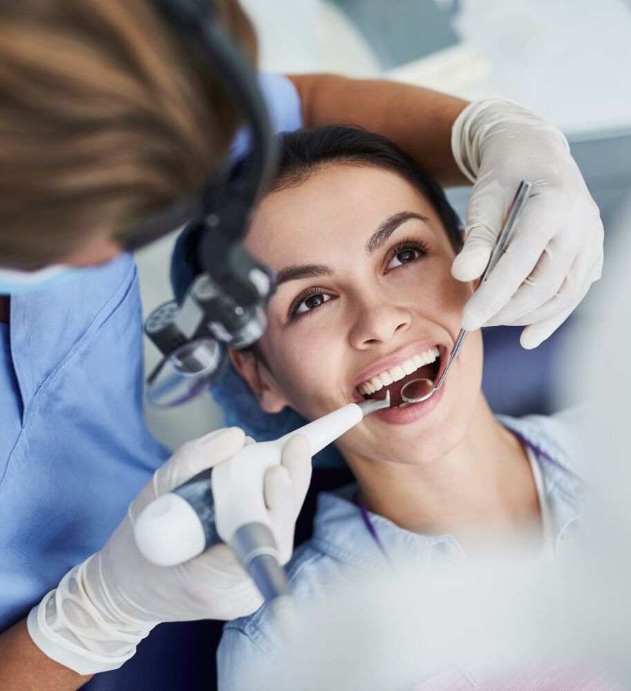 charming young woman receiving dental treatment at clinic