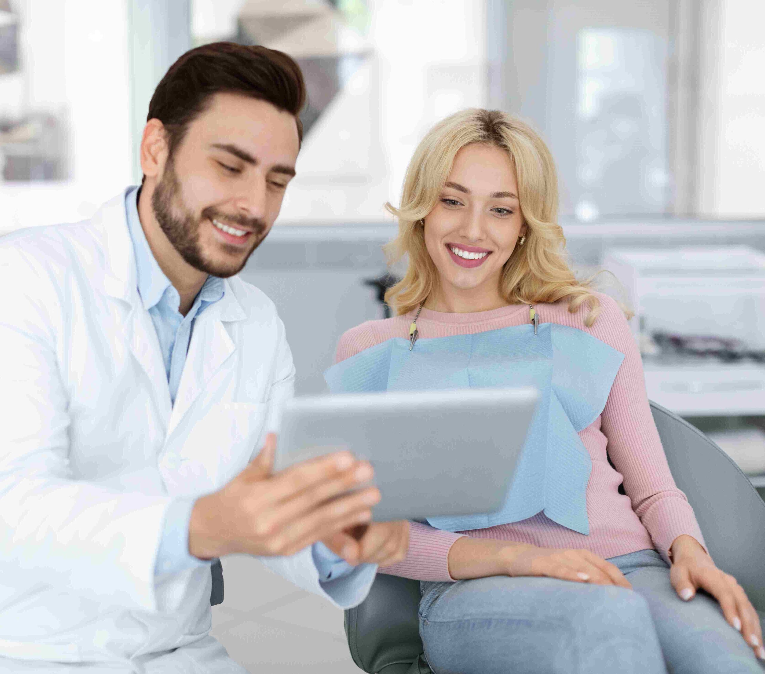 cheerful man dentist discussing treatment with beautiful lady patient