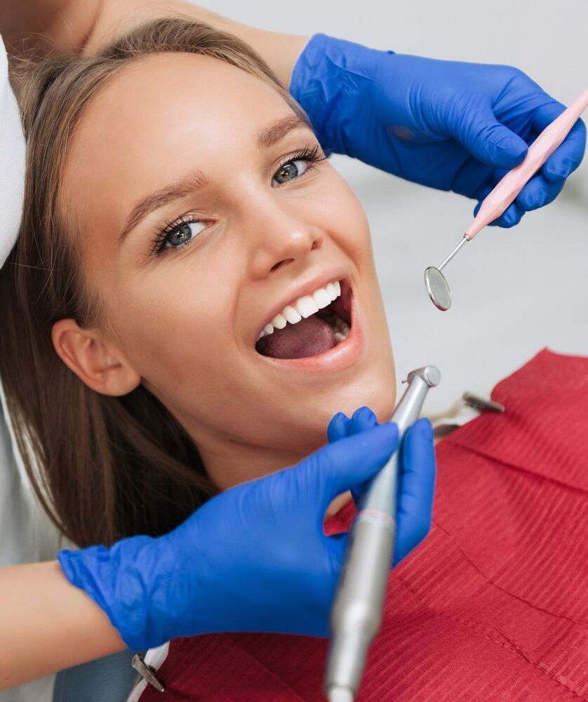 close up of female patient having her teeth examined by specialist