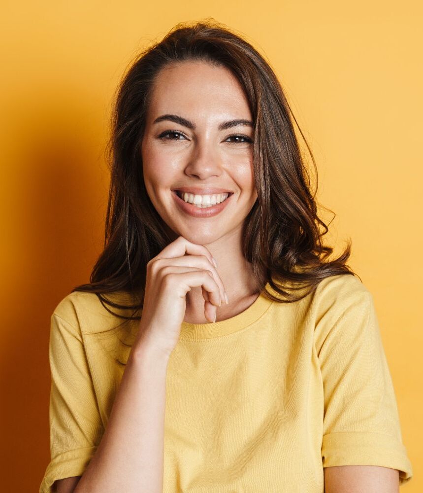 image of joyful brunette woman smiling and looking at camera