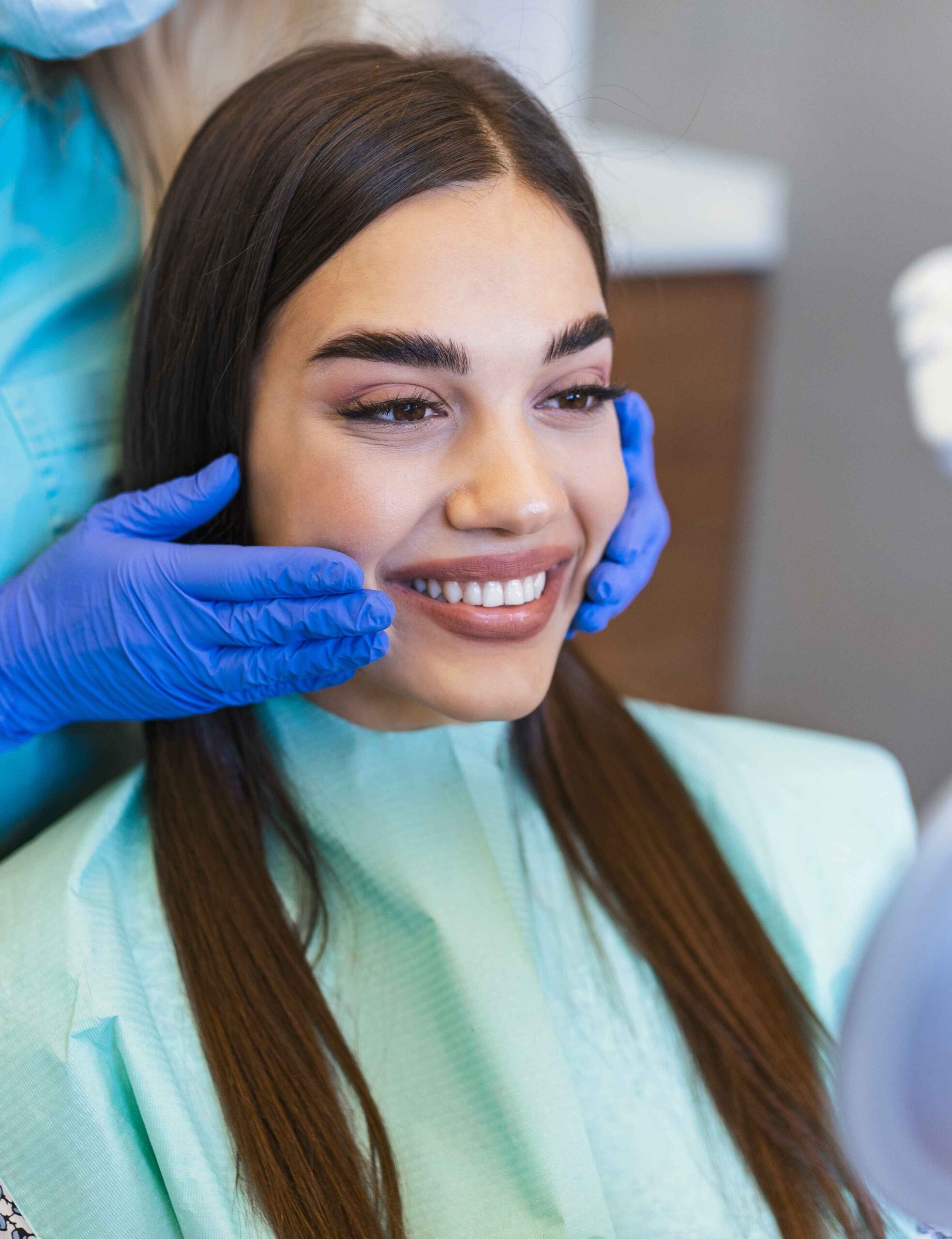 woman looks in the mirror in dentist chair viewed oral hygiene woman at the dentist woman in the dental chair dental treatment during surgery