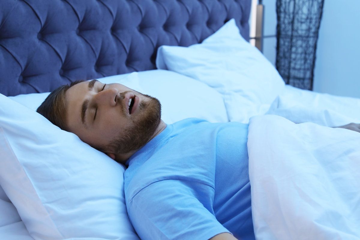 Man sleeping peacefully in bed.