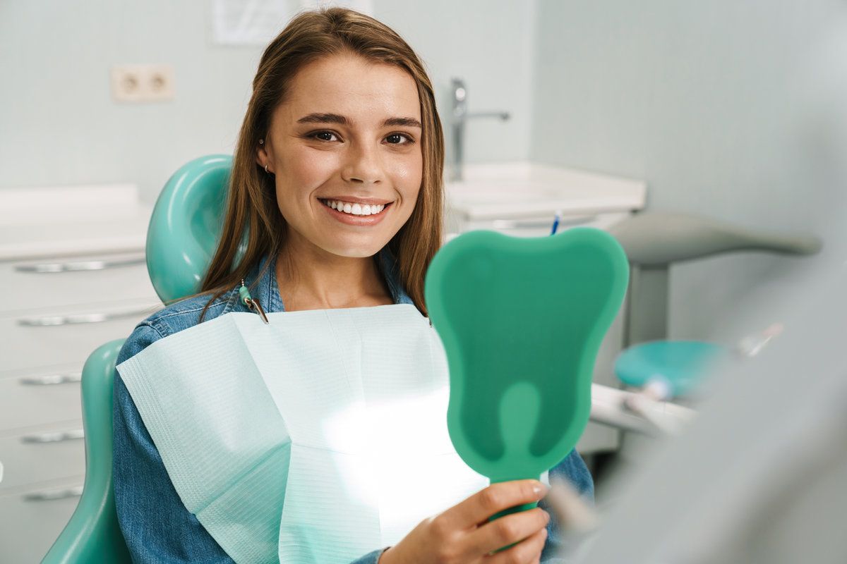Smiling woman at dental appointment.