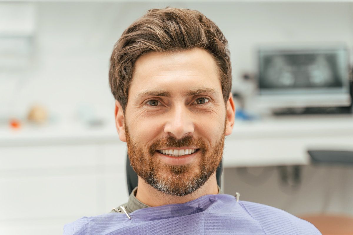Smiling man in dental chair.