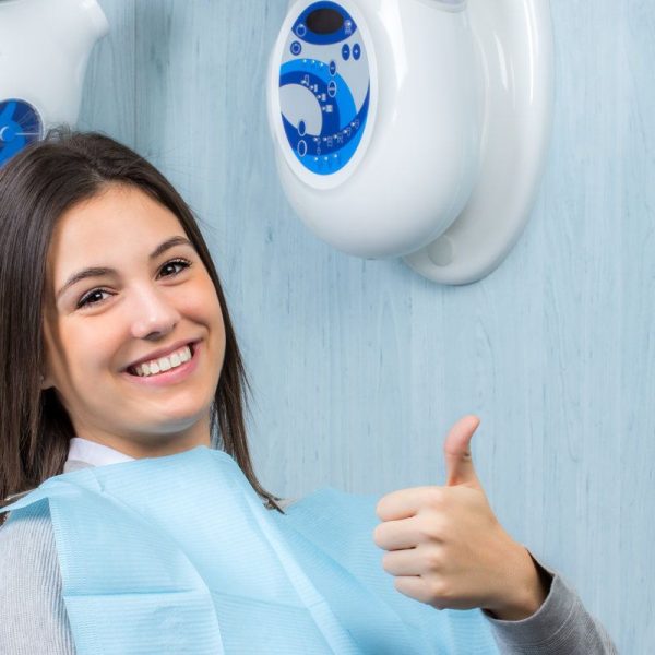 Smiling patient in dental chair.