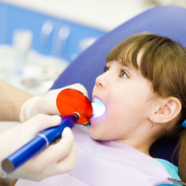 Child at dentist with dental equipment