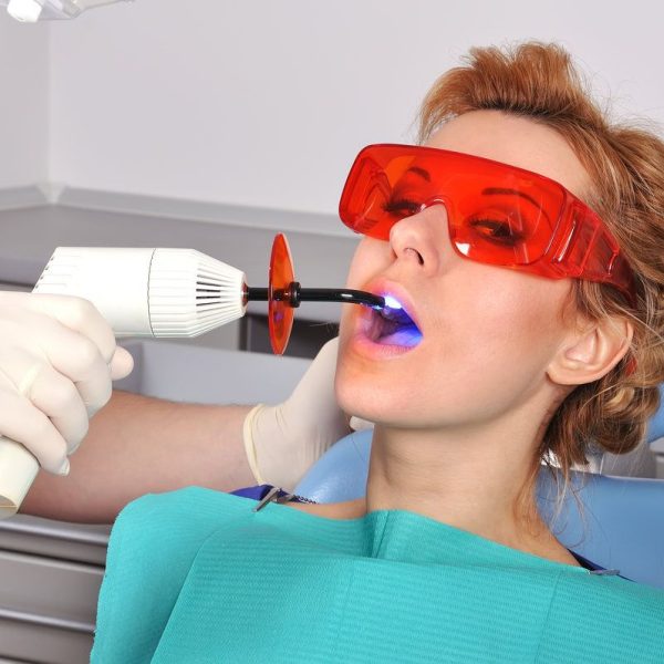 Patient receiving dental treatment with laser